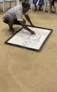 Uncle Edgar, drawing on the sand, sharing the ‘reconciliation’ episode of his gospel-shaped traditional story.